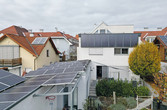 Ein Wohnhaus mit Solarthermie-Kollektoren an der Fassade zur Warmwasserbereitung