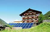Ein Haus mit freistehender Solaranlage im Garten