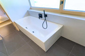 Badewanne mit schwarzen Armaturen